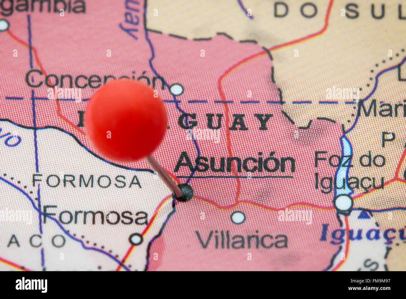 Close-up of a red pushpin in a map of Asuncion, Paraguay. Stock Photo
