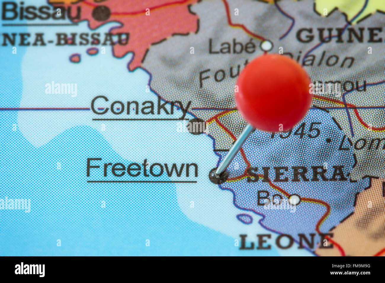 Close-up of a red pushpin in a map of Freetown, Sierra Leone. Stock Photo