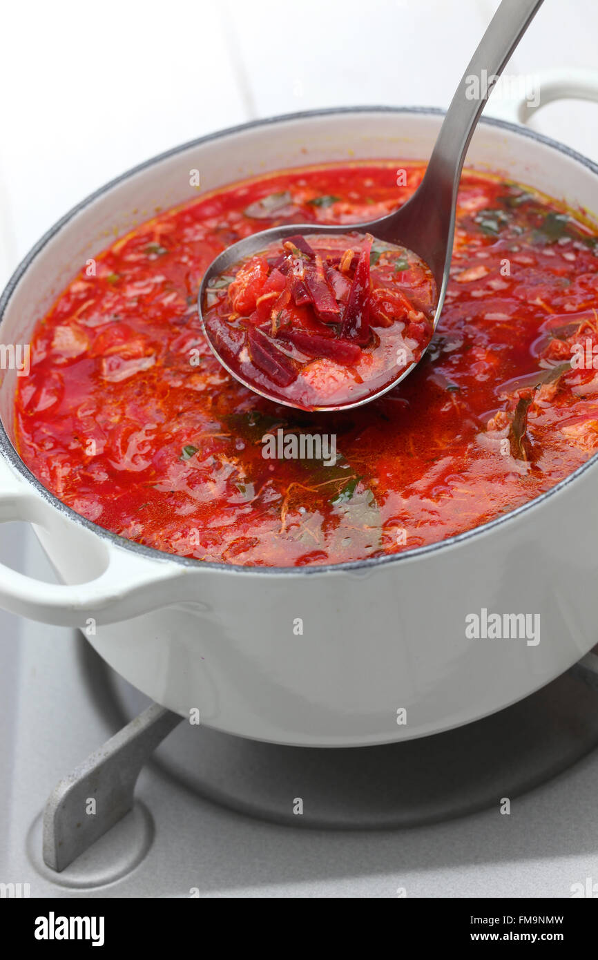 serving borscht ( beet soup ) with a ladle, russian ukrainian cuisine Stock Photo
