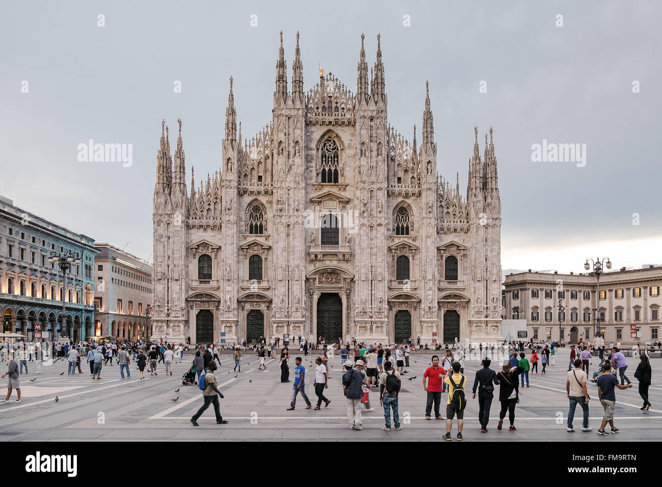 Milan, Italy - August 26, 2013: Piazza Duomo, a multitude of people animate the square in front of the main symbol of the city. Stock Photo