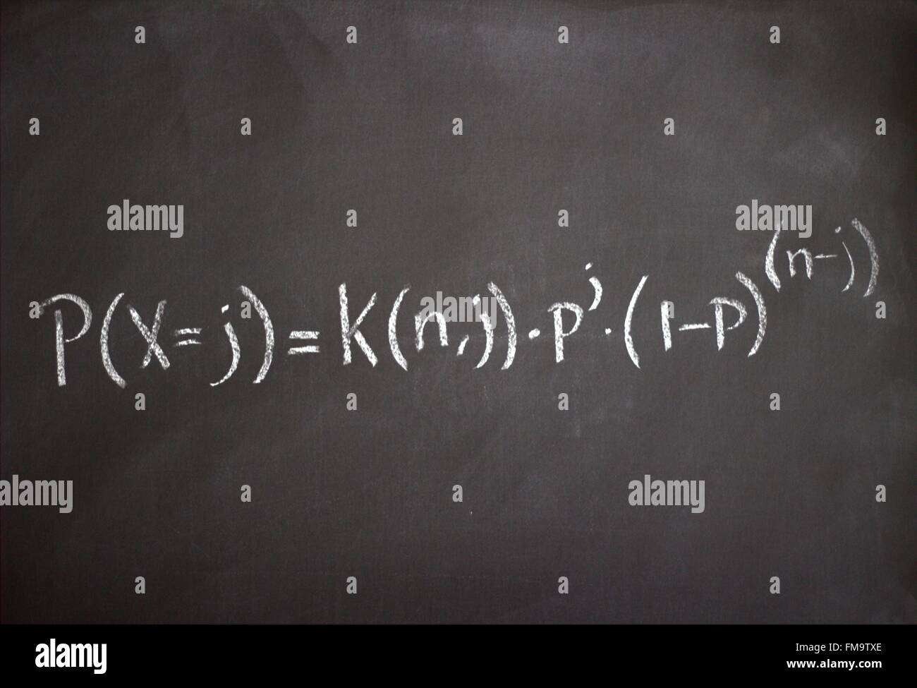 Studying the science of mathematics and economics on a blackboard Stock