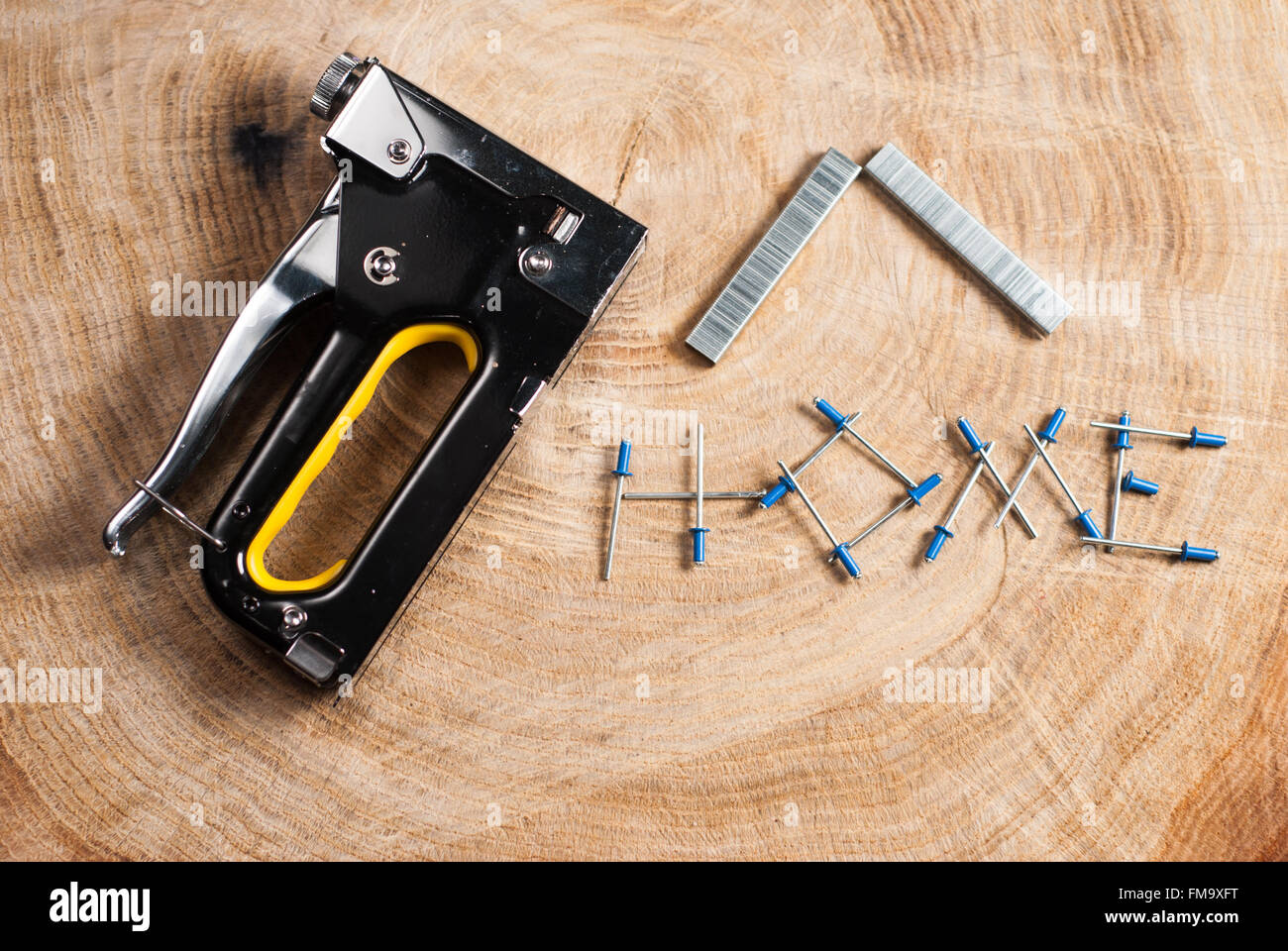 construction stapler on wooden background and text Stock Photo Alamy