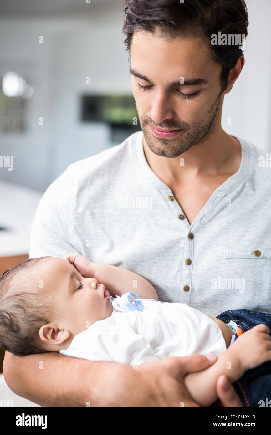 Father carrying sleeping baby Stock Photo Alamy
