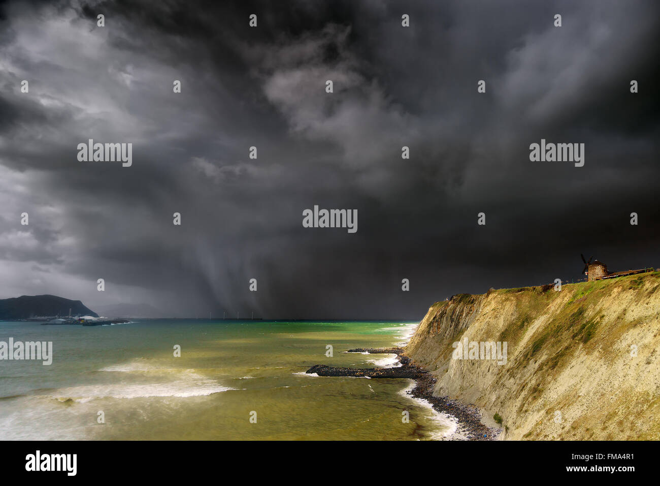 aixerrota mill in Getxo with stormy dark clouds Stock Photo