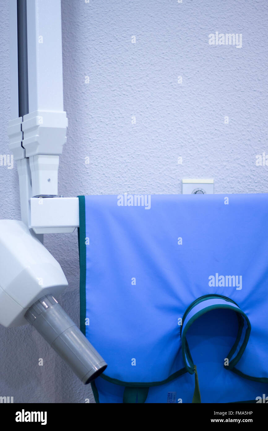 Dentist's xray machine and radiation vest in hospital clinic Stock