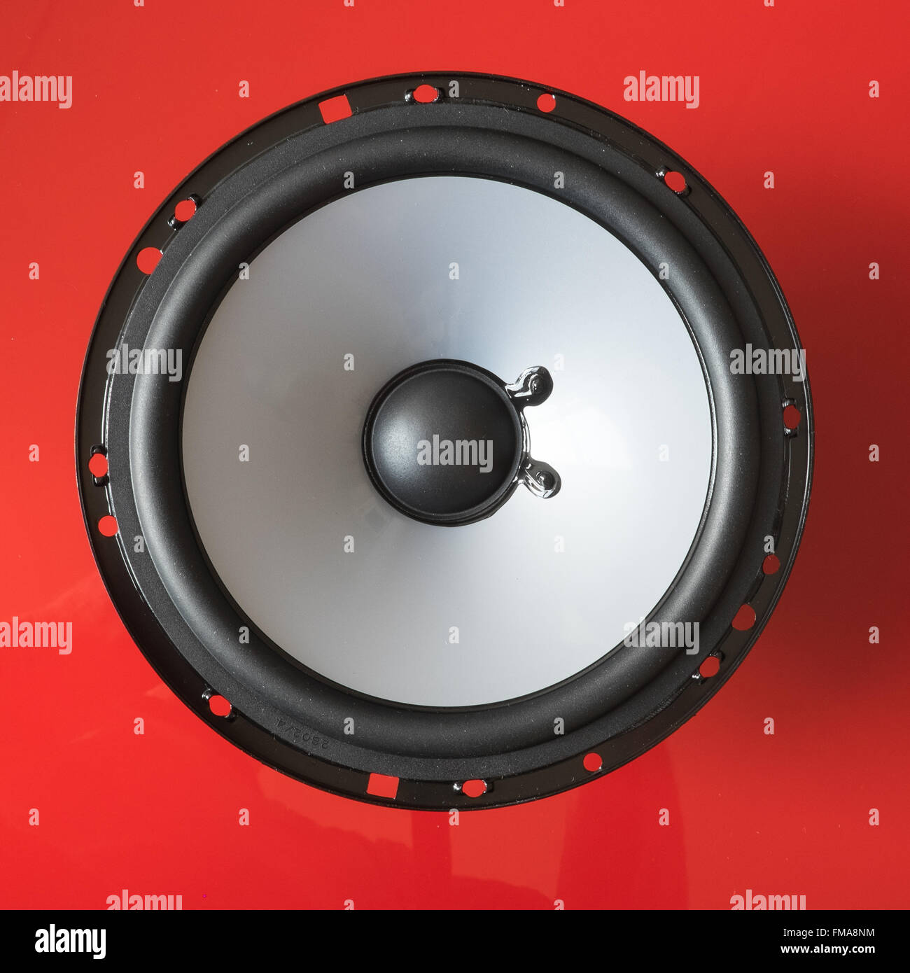 Speaker bass componenet on red background Stock Photo