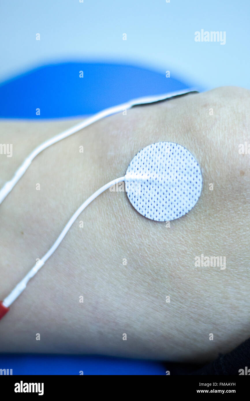 Physical therapy clinic of hospital. Patient having electrical impulse physiotherapy treatment