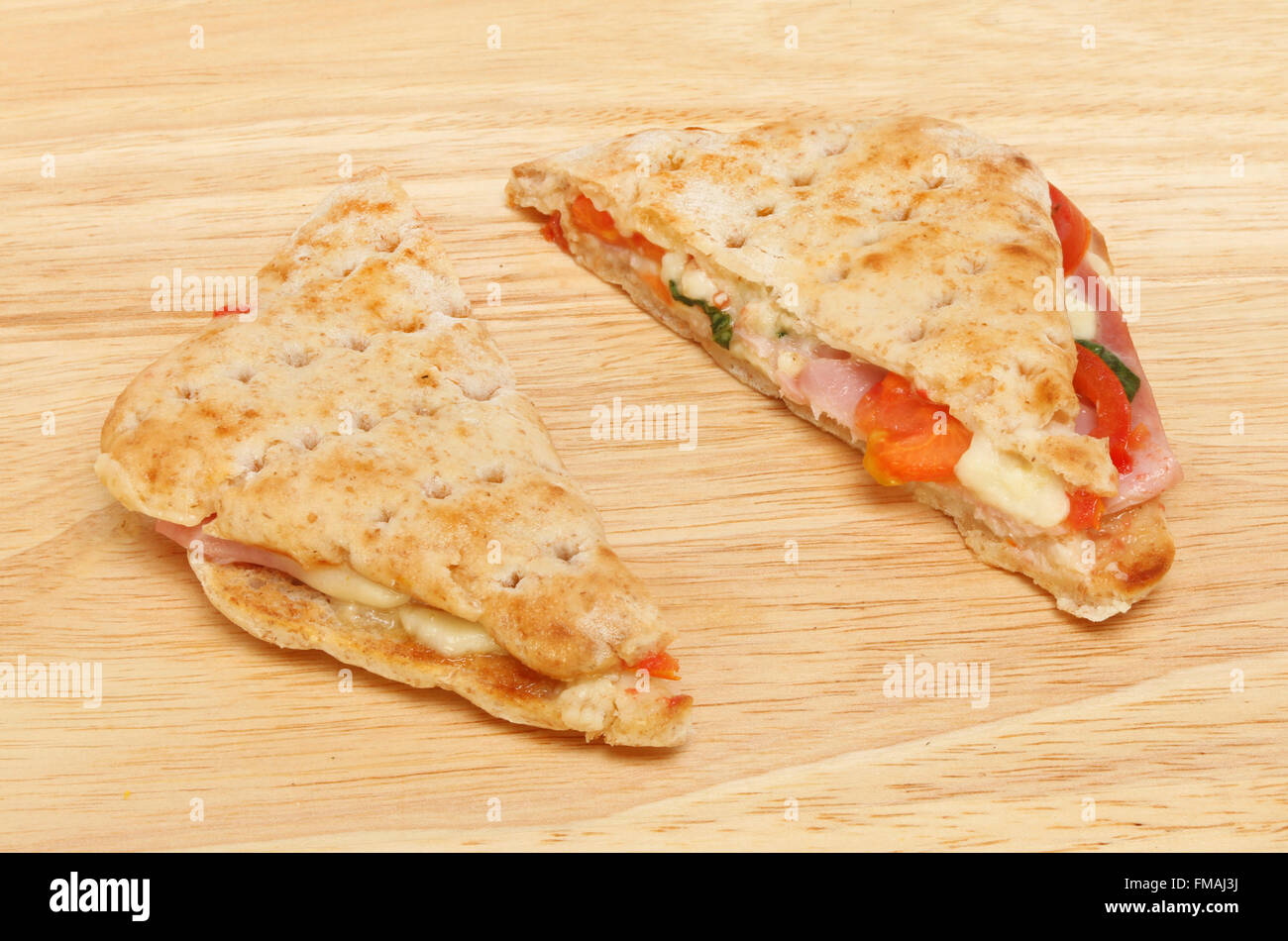 Toasted ham, Mozzarella, Cheddar cheese, tomato and basil sandwich made