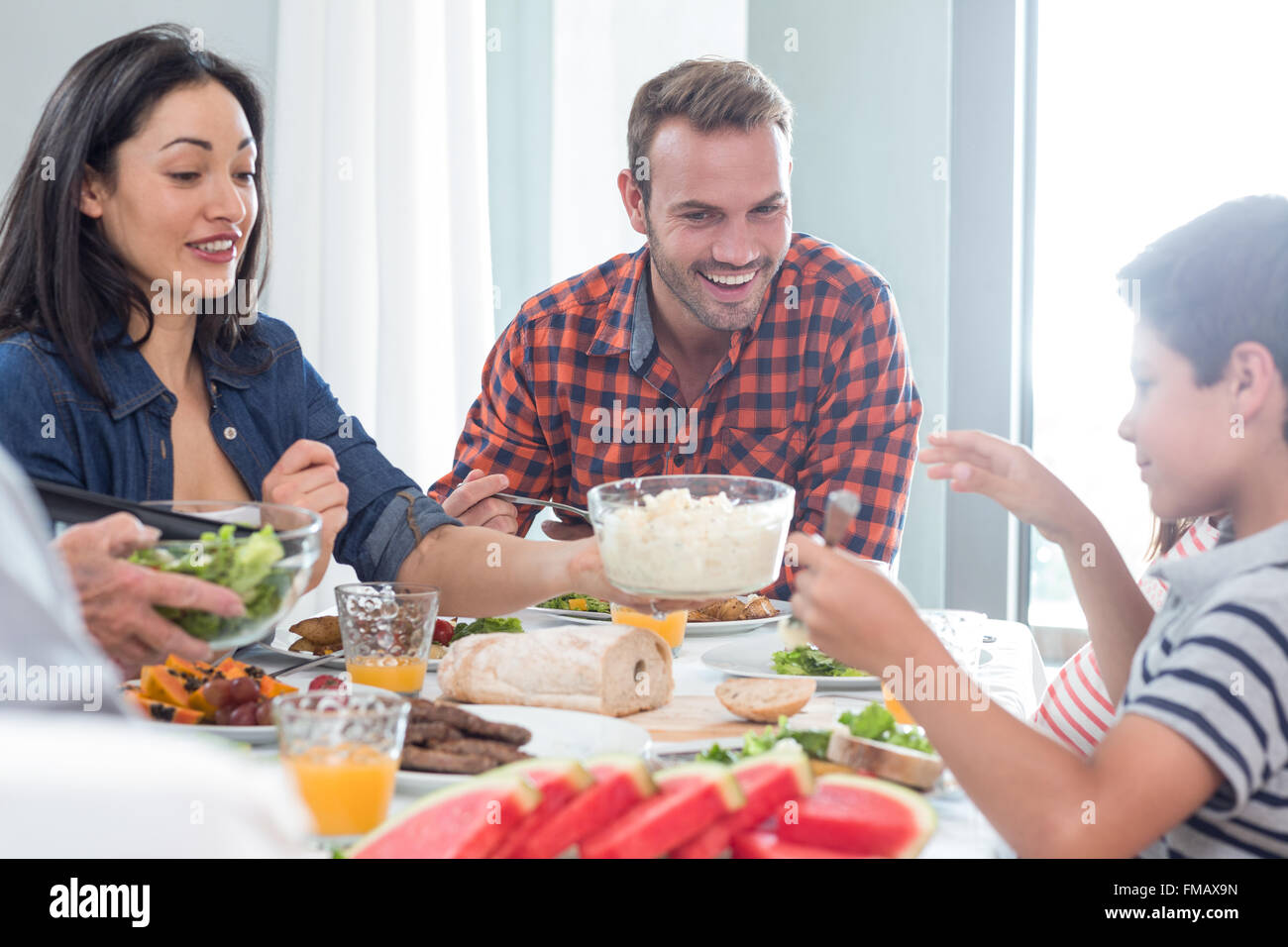Happy family having breakfast Stock Photo - Alamy