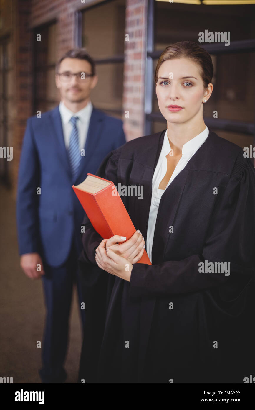 Female lawyer with businessman standing in background Stock Photo