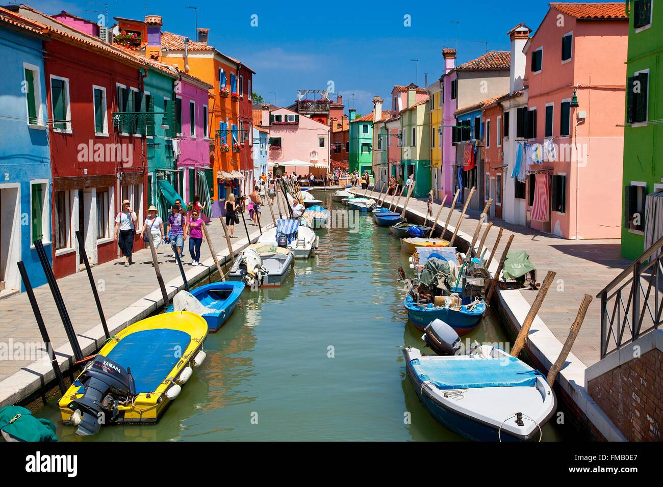 Italy, Veneto, Venice, Colorful Boats and Homes Lining Canal in Burano Stock Photo