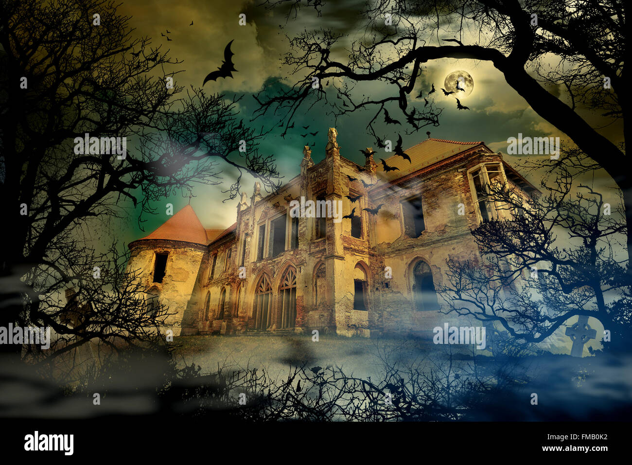 Haunted castle in creepy foggy background with tree silhouettes. Stock Photo