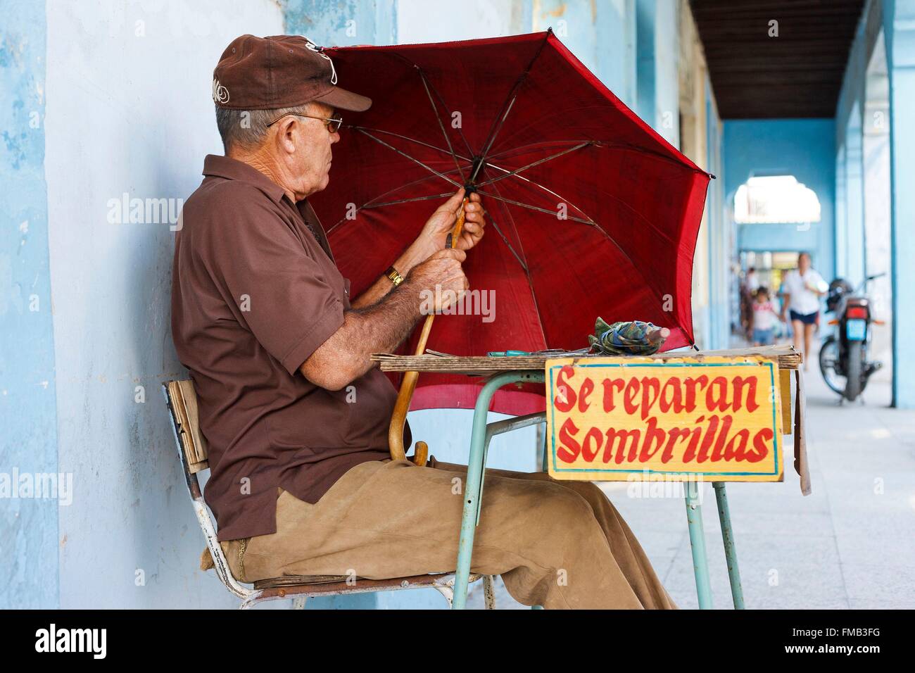 Cuba, Las Tunas, Repairer of umbrellas Stock Photo