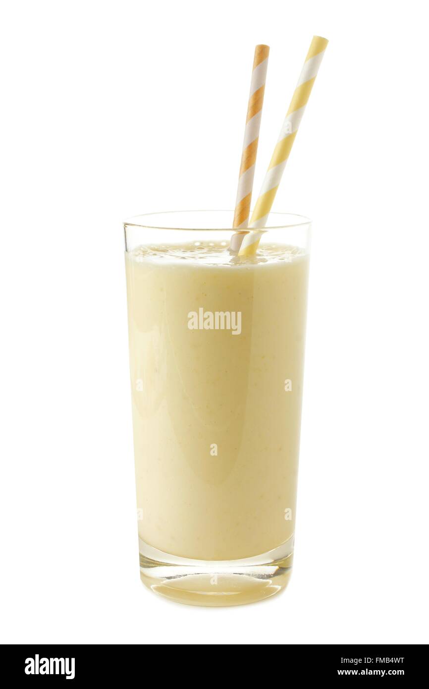 Healthy banana smoothie in a glass with straws isolated on white Stock Photo