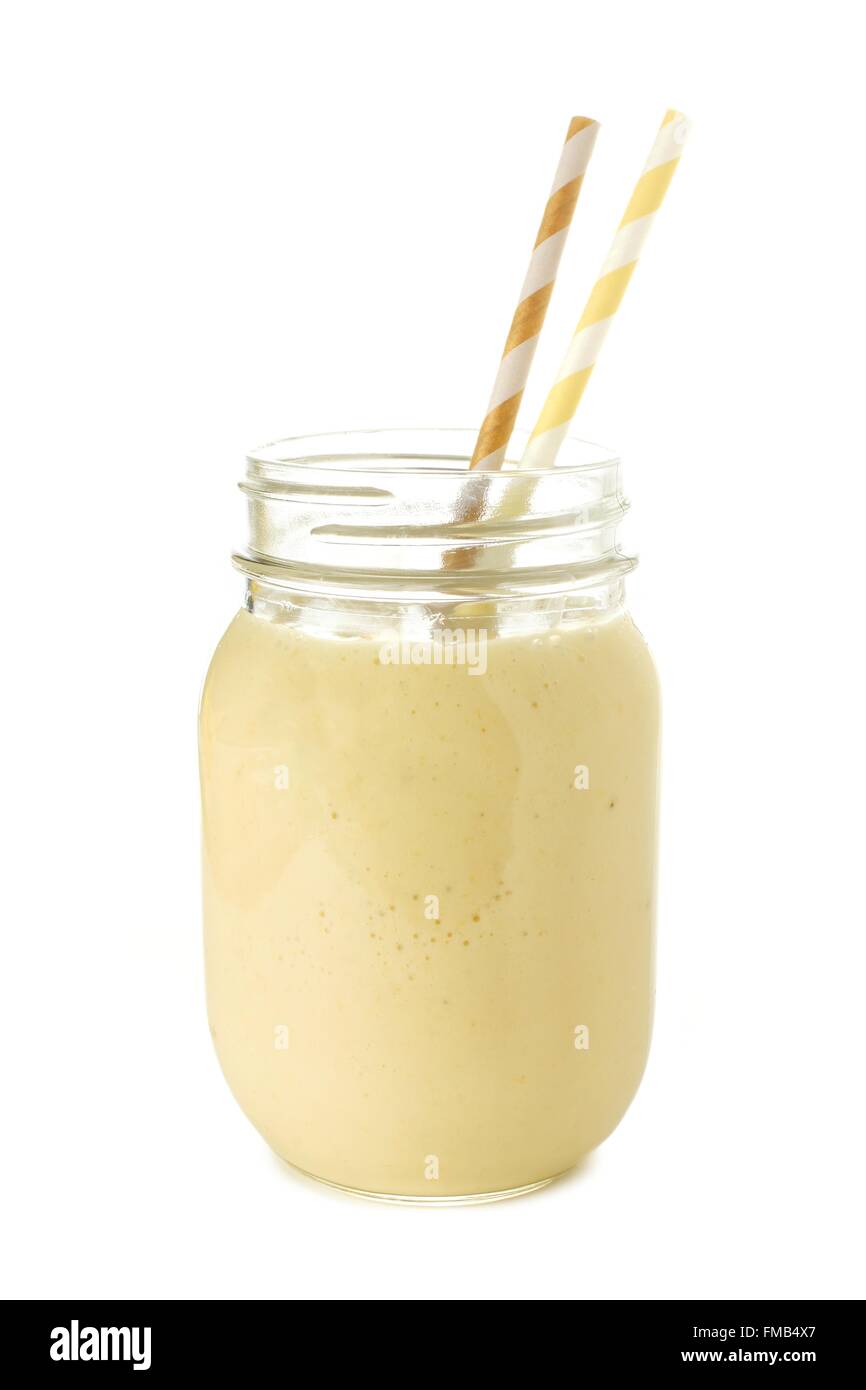 Banana smoothie in a mason jar with straws over white Stock Photo