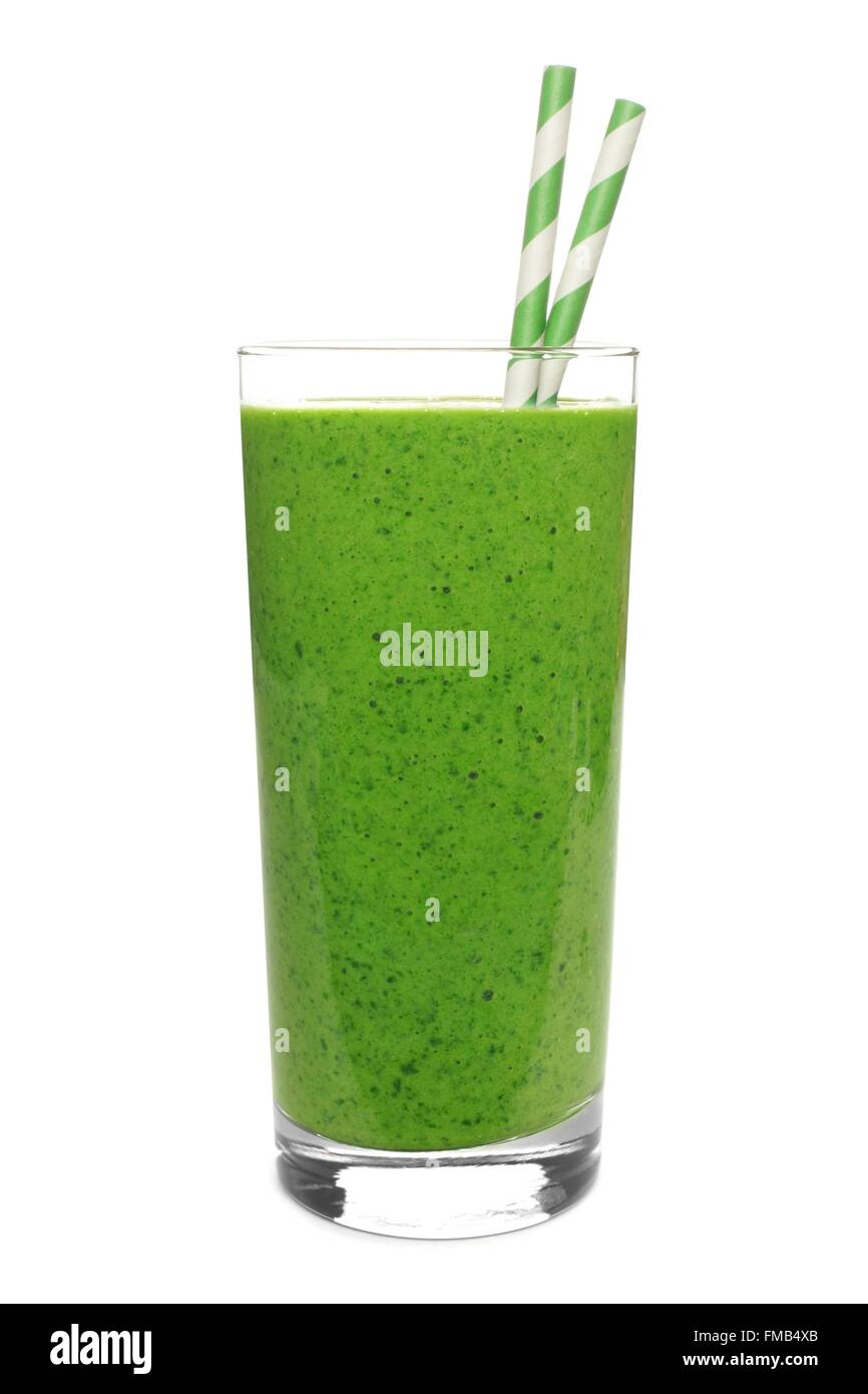 Green smoothie in a glass with straws isolated on a white background Stock Photo