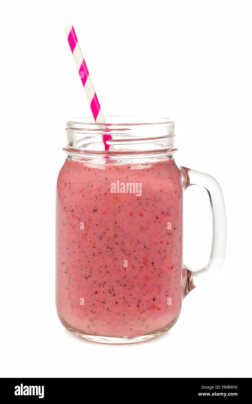 Pink raspberry, dragon fruit smoothie in mason jar glass isolated on white Stock Photo