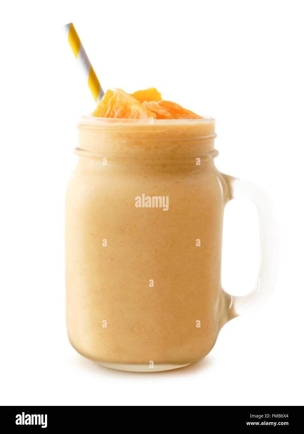 Orange smoothie in a mason jar glass with striped straw isolated on a white background Stock Photo