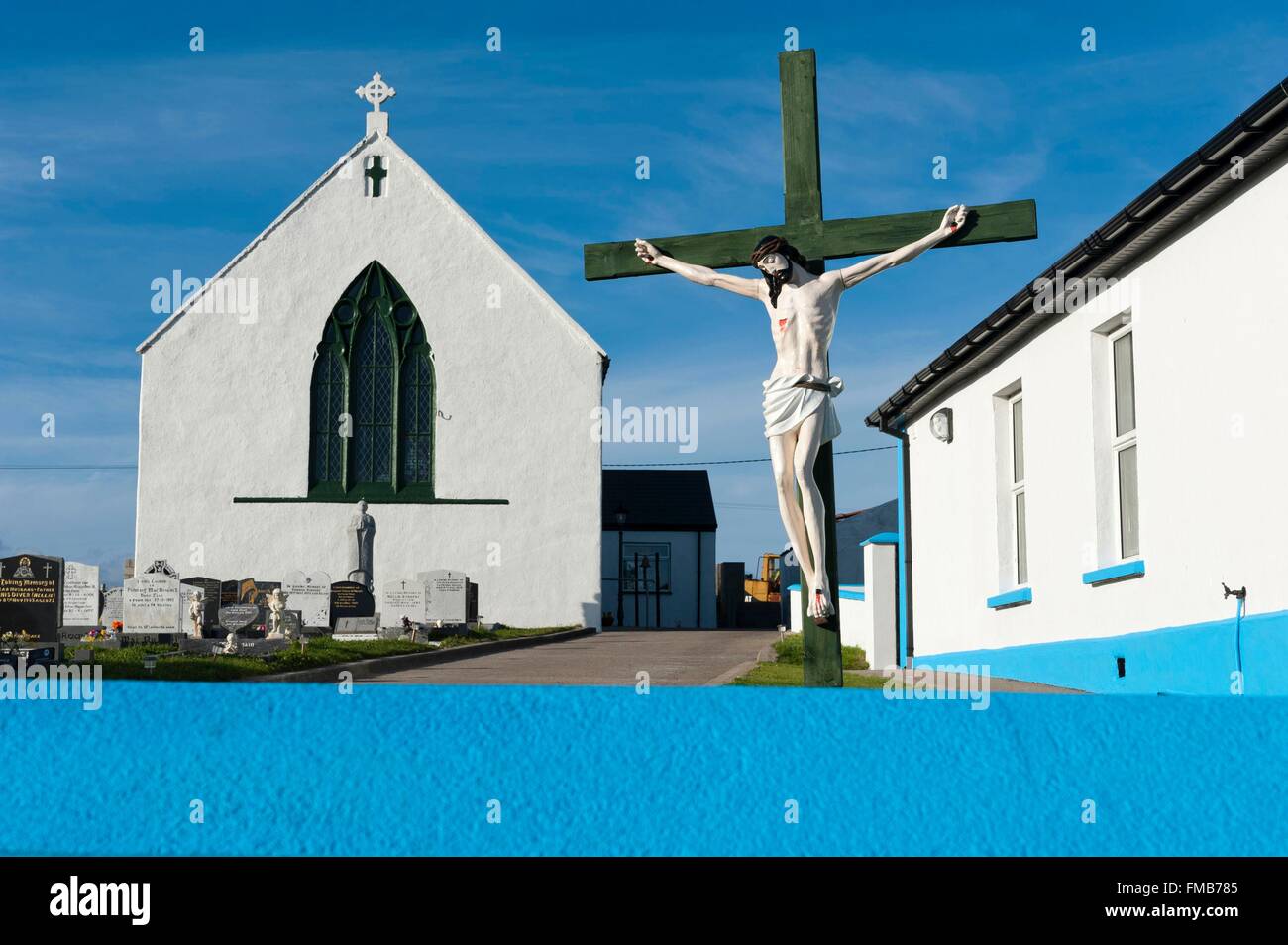 Ireland, County Donegal, Tory Island, Christ on the cross, church and cemetery, blue wall Stock Photo