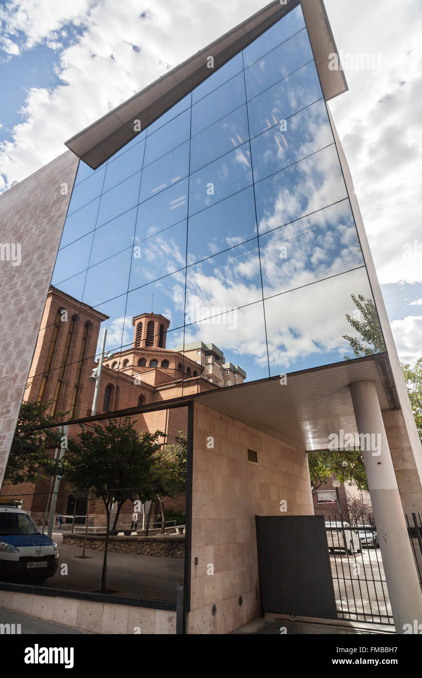 Church Santa Maria and reflection in glass facade of town hall,Cornellà de Llobregat,Catalonia,Spain. Stock Photo