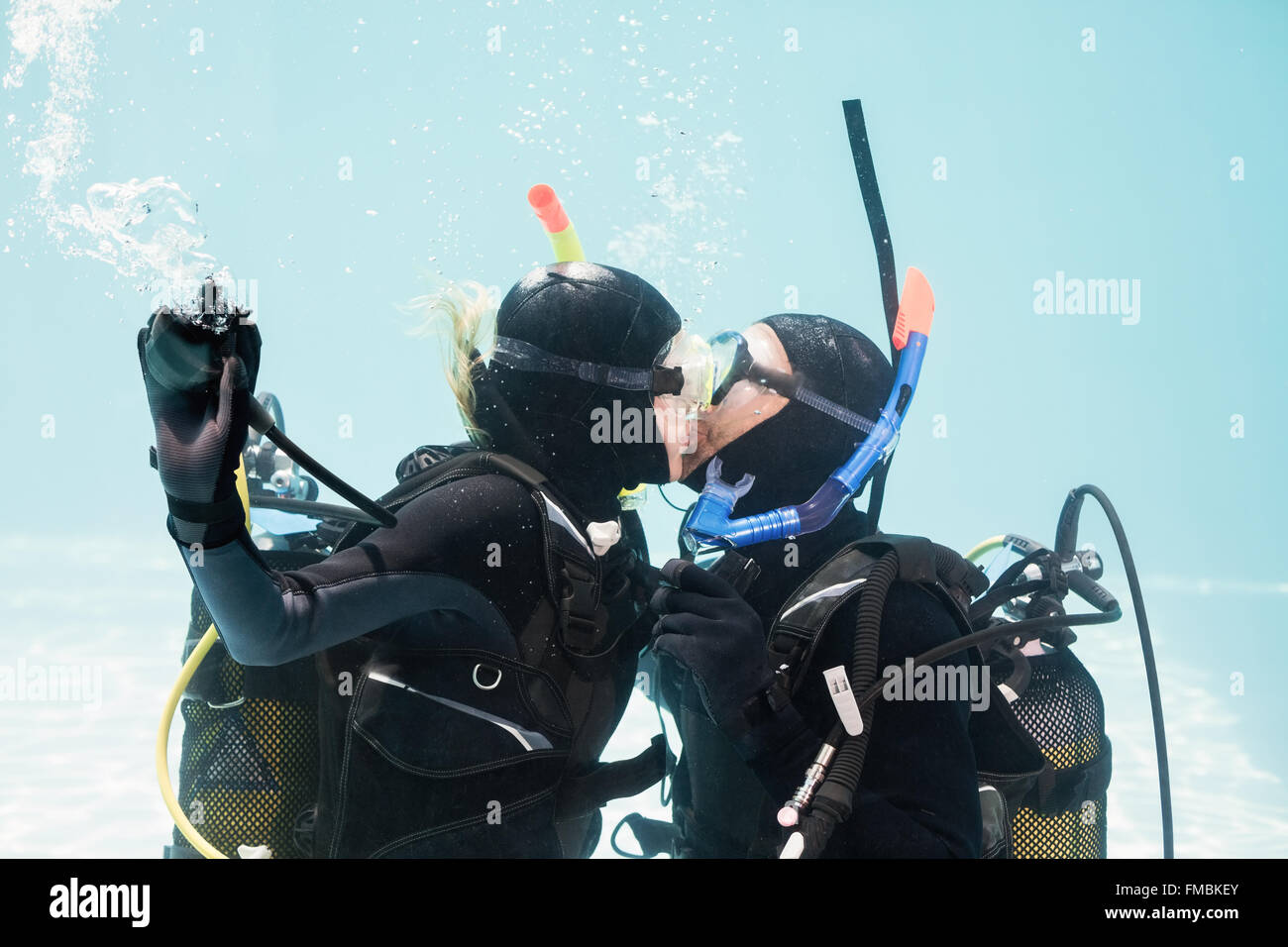 Couple kissing underwater while scuba diving Stock Photo Alamy