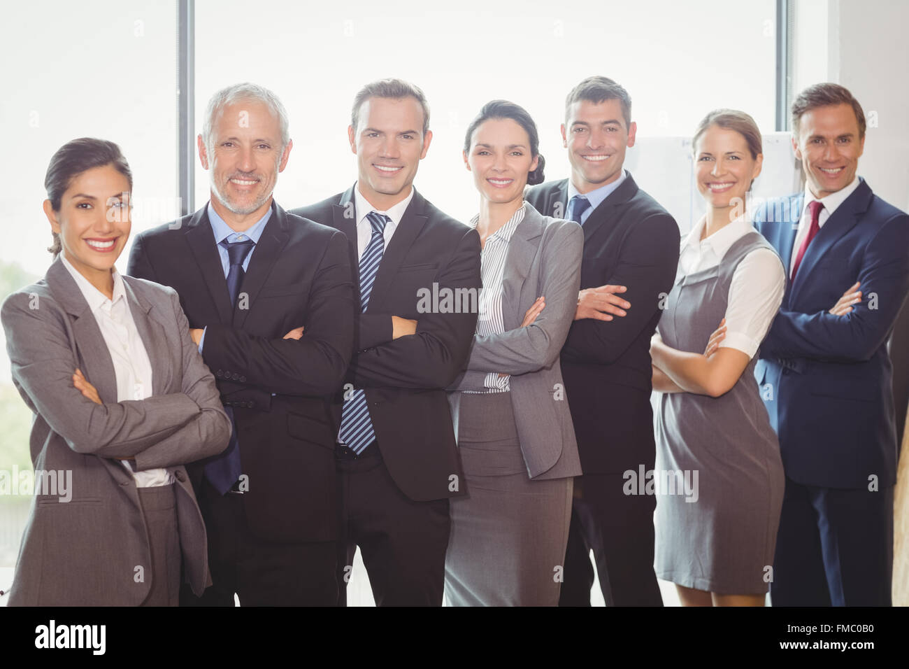 Team of businesspeople posing together Stock Photo - Alamy