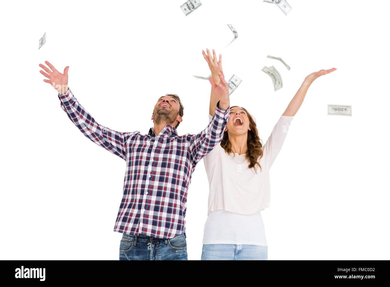 Happy young couple throwing currency notes in air Stock Photo - Alamy