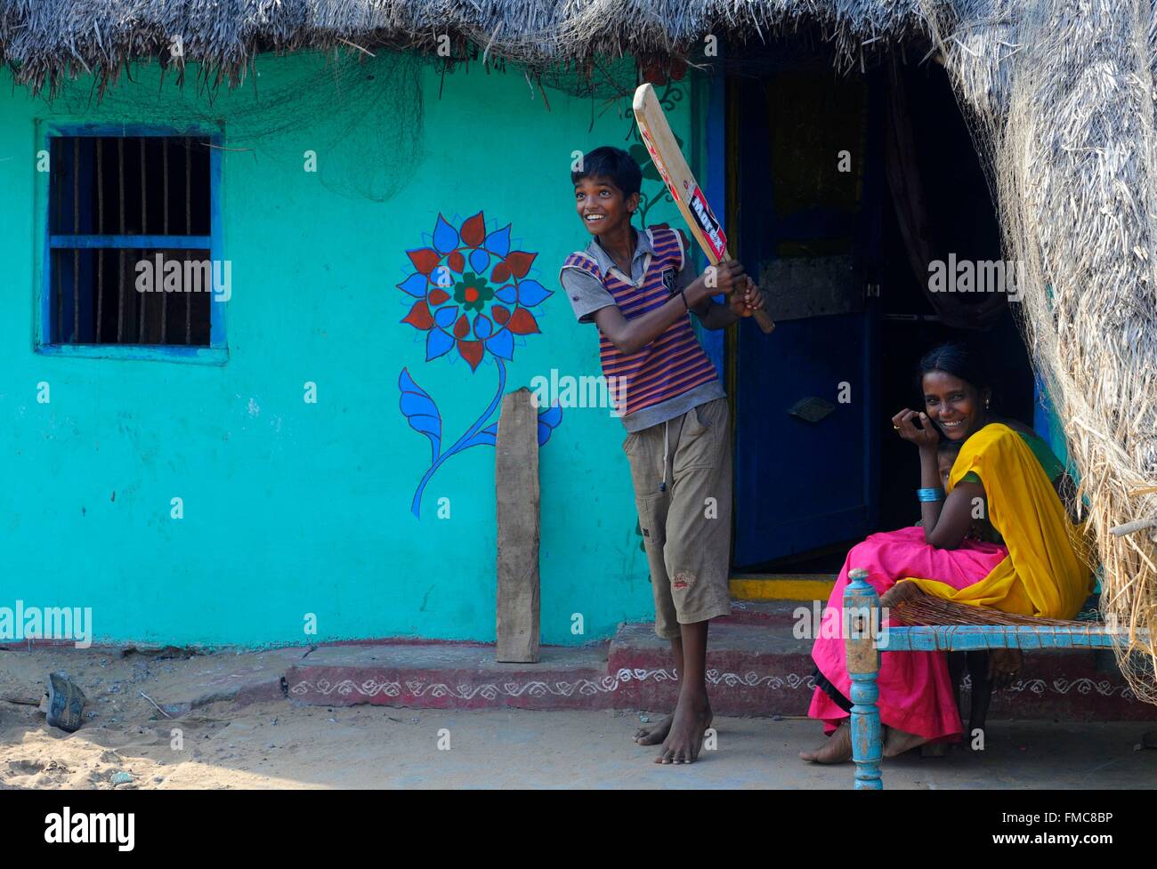 India, Odisha, a kid plays criket Stock Photo