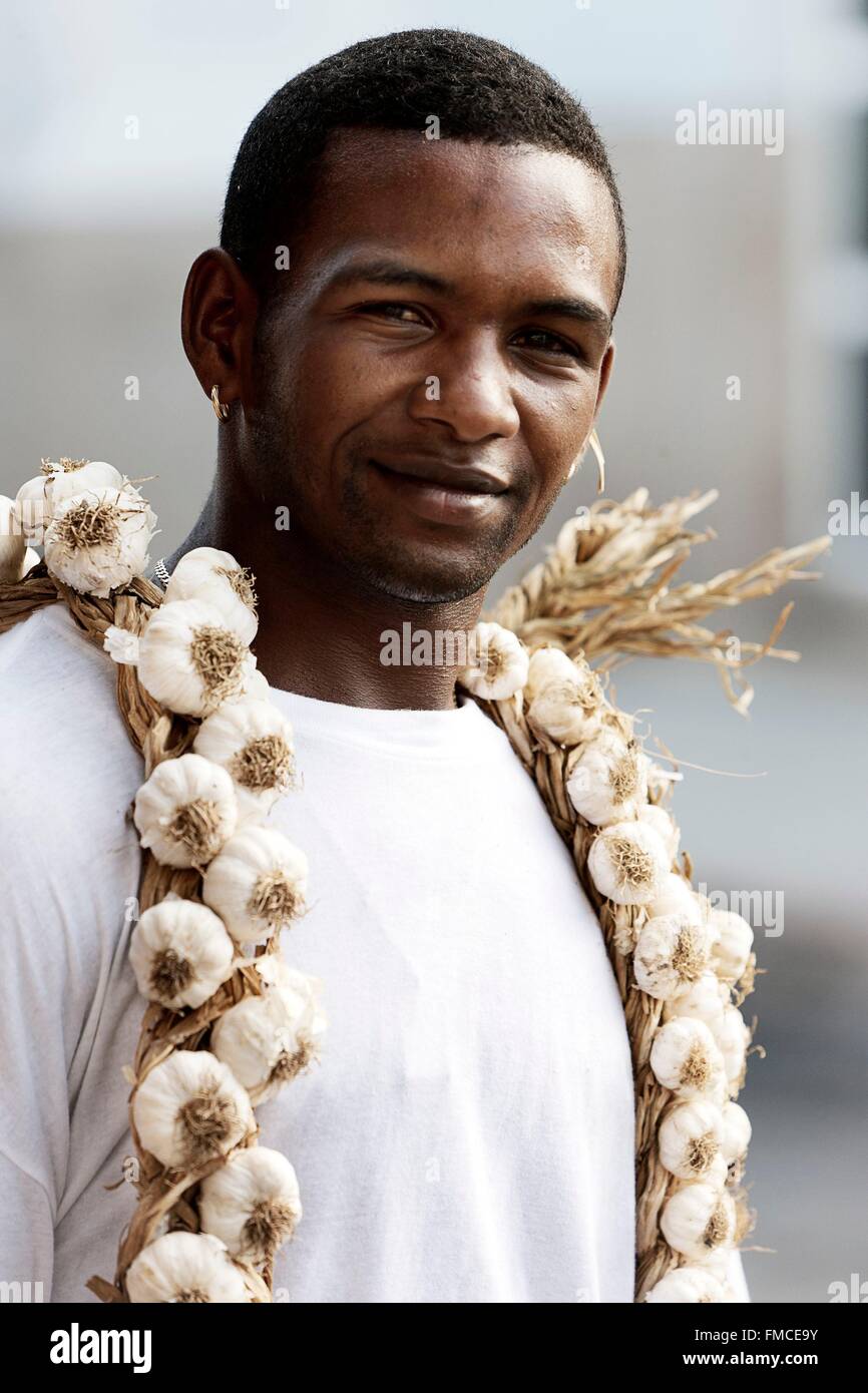Cuba, Cienfuegos, Young man with a garlic necklace around the neck Stock Photo