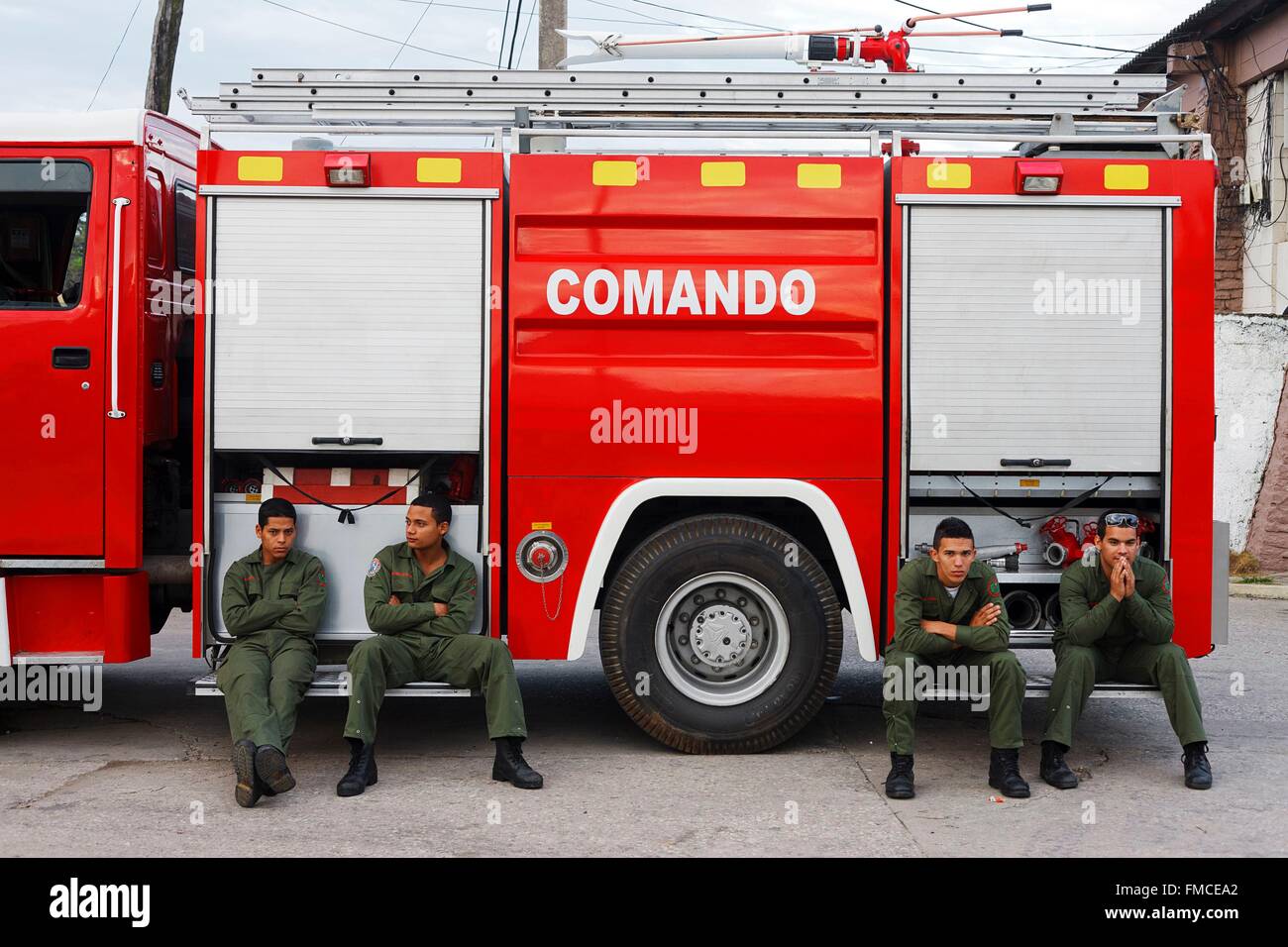 Cuba, Villa Clara, Santa Clara, Firemen sitting by their truck Stock Photo