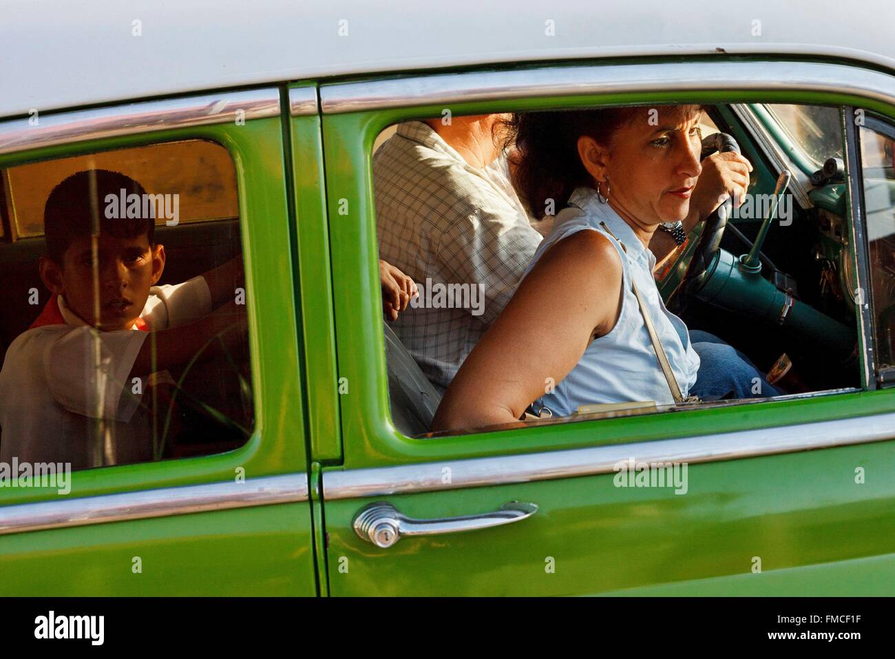 Cuba, Camaguey,listed as World Heritage by UNESCO, Family in a green American Stock Photo
