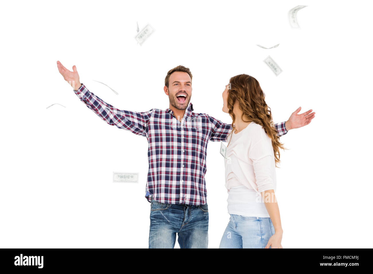 Happy young couple throwing currency notes in air Stock Photo - Alamy