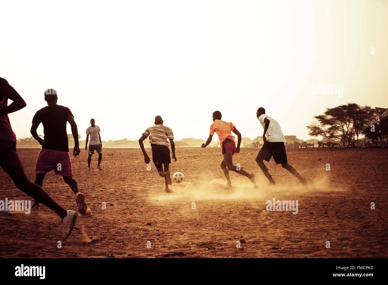 Senegal, Sahel, Ferlo region, Widou Thiengoly, Football players at sunset Stock Photo