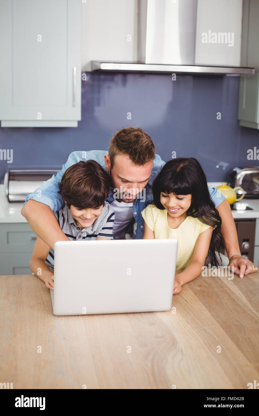 Father and children using laptop Stock Photo - Alamy