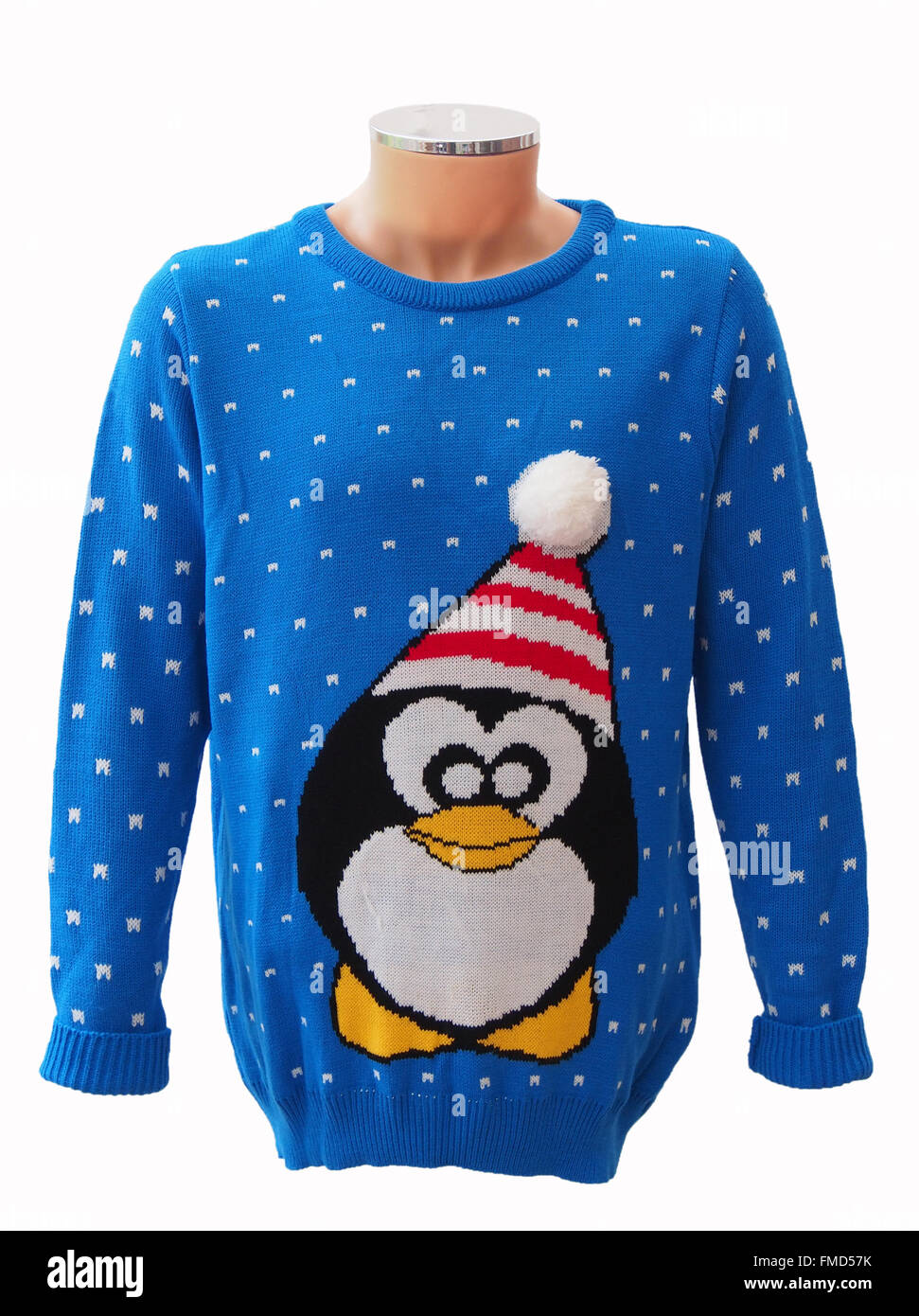 Blue knitted adults' Christmas jumper on a mannequin, featuring a penguin and snowflakes, isolated on a white background. Stock Photo