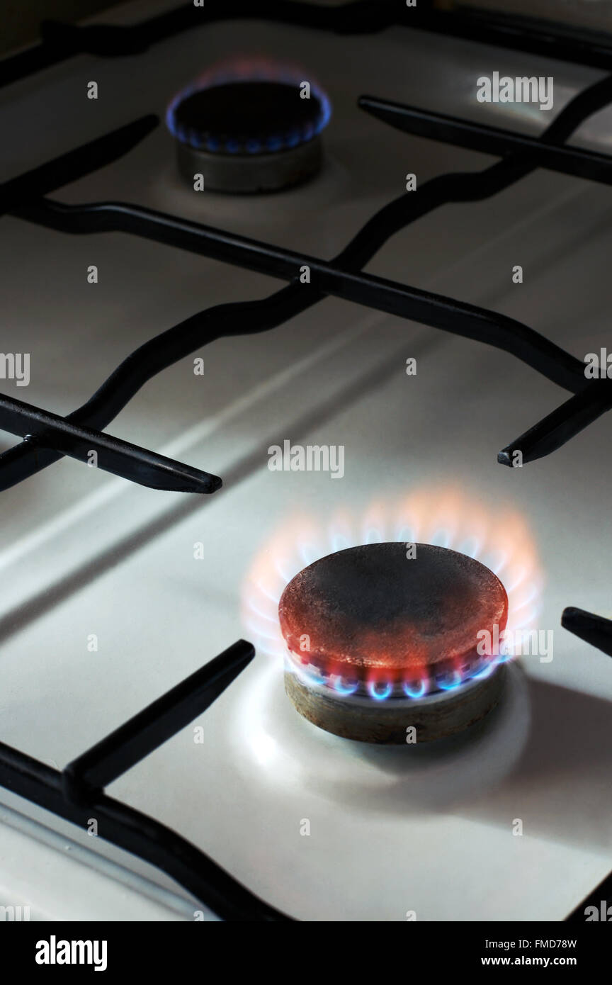 Rusty Rabge Cooker Old and rusty kitchen-range with burning gas Stock Photo - Alamy