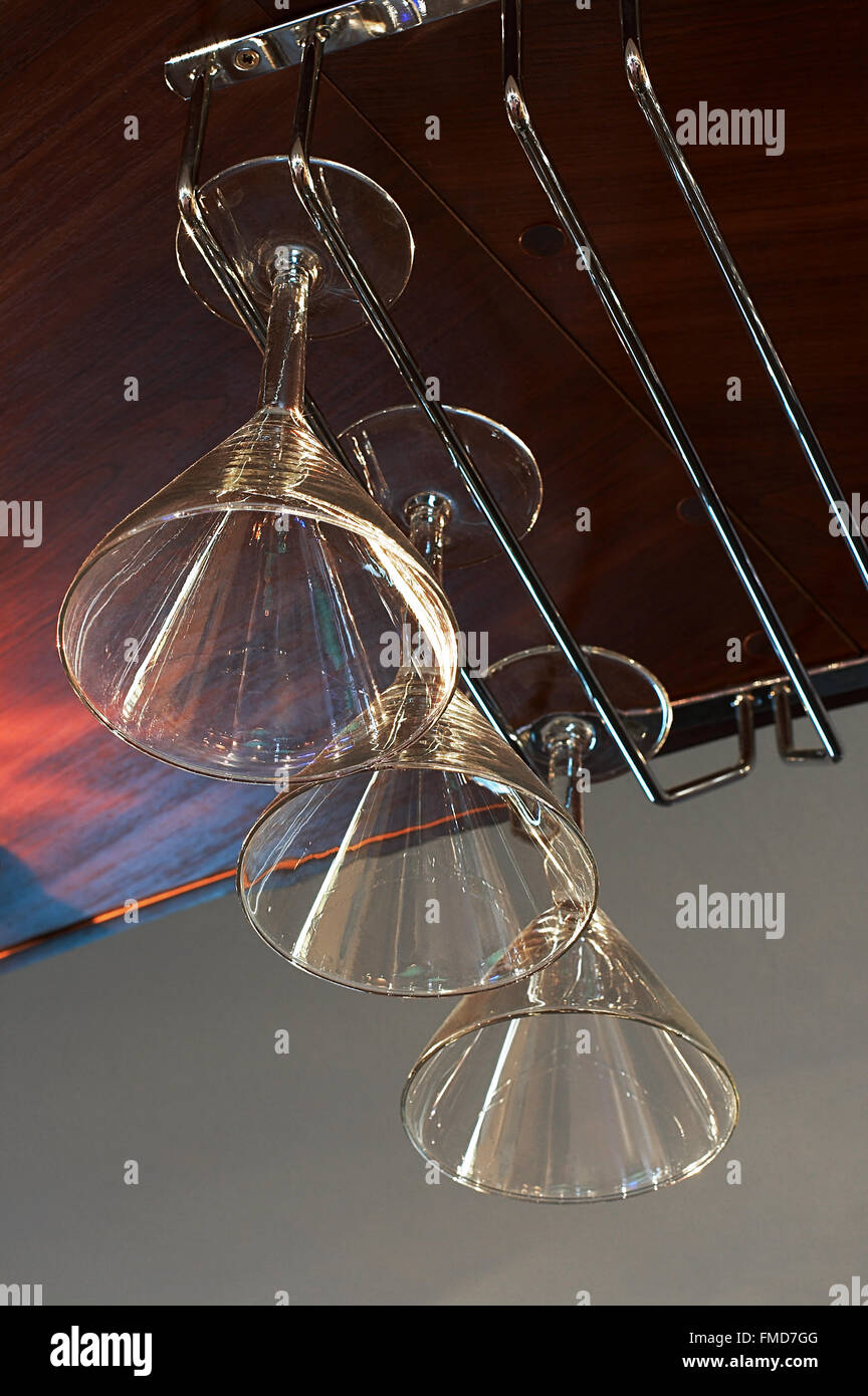 Empty glasses for wine above a bar rack Stock Photo - Alamy