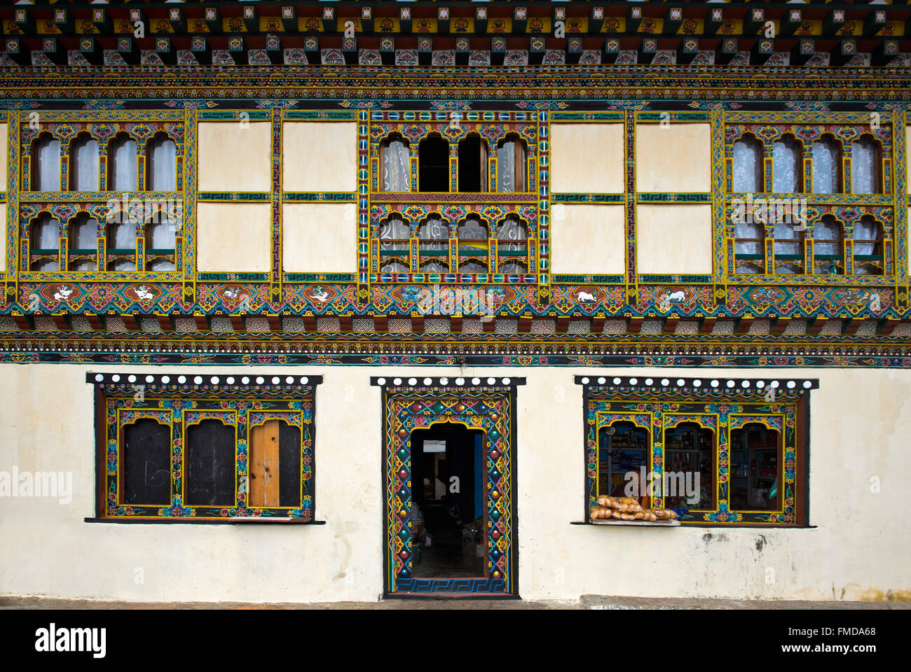 Colorful decorations on windows and doors, traditional Bhutanese architecture, Lobesa, Bhutan Stock Photo