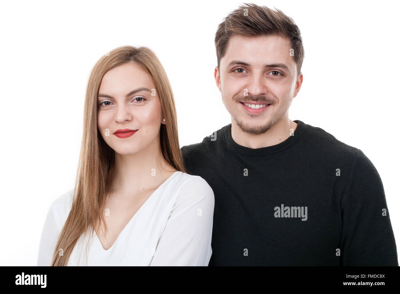Young couple standing close to each other in studio Stock Photo