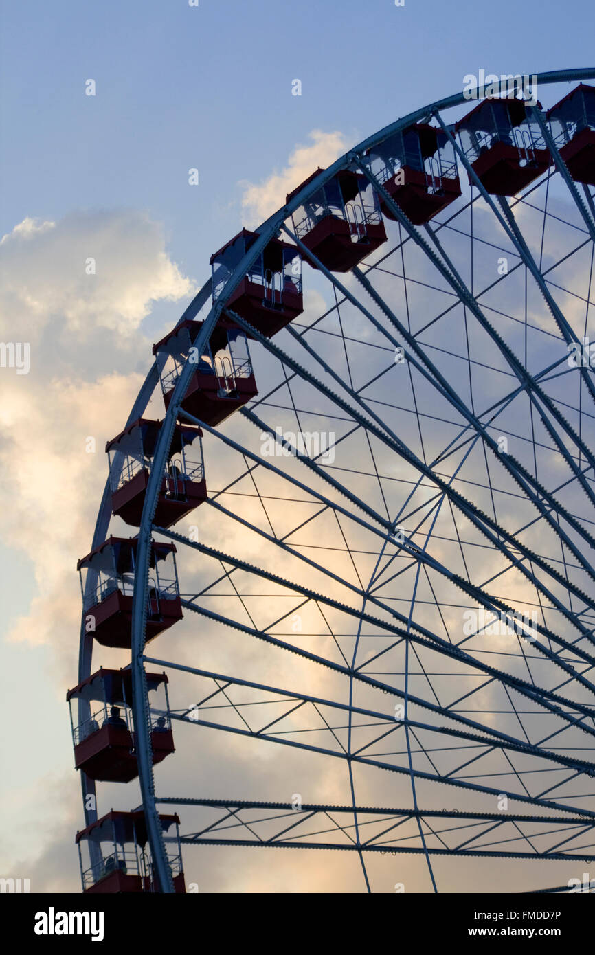 Ferris wheel against dark storm clouds Stock Photo