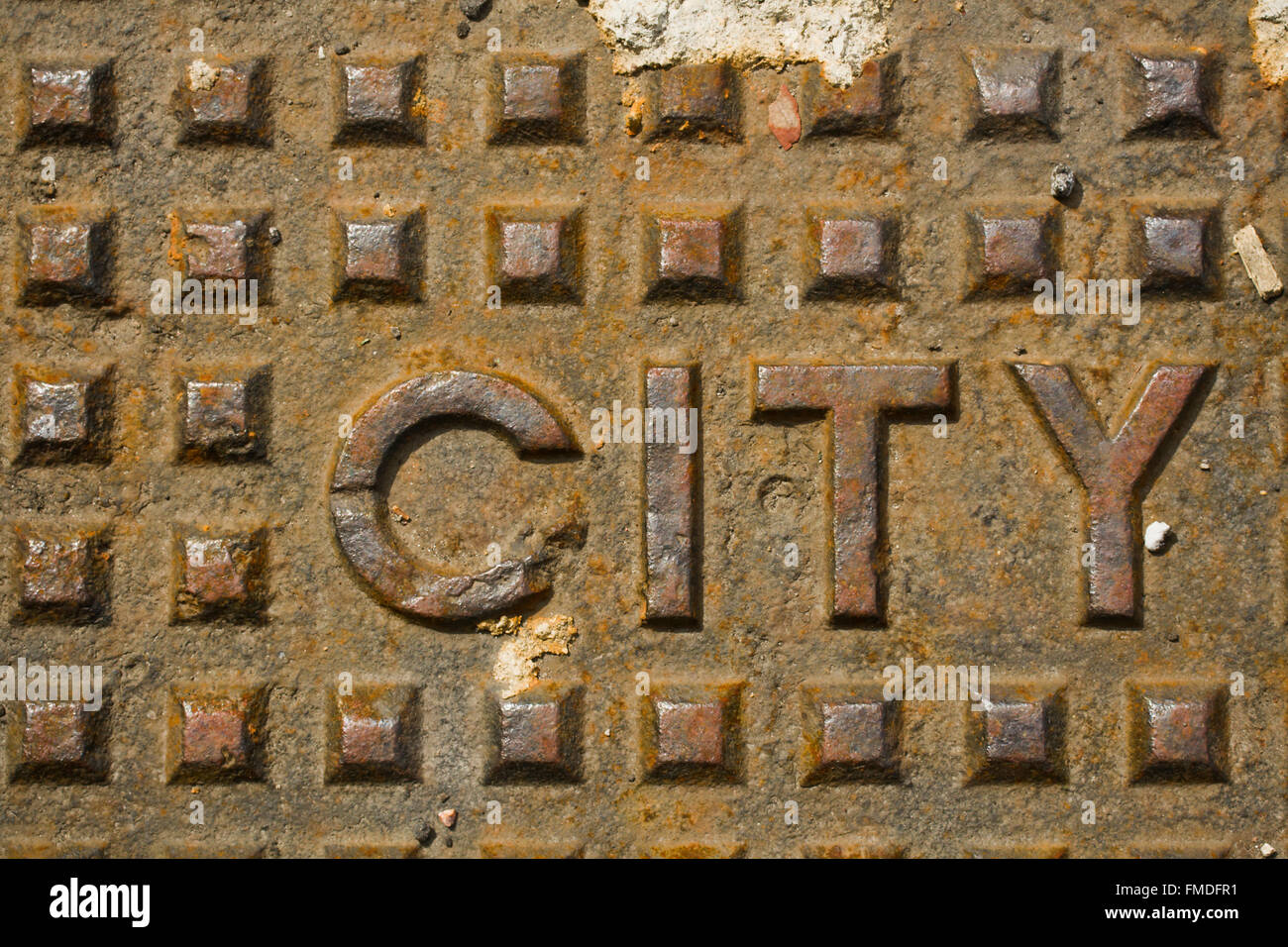 Manhole Cover with the word CITY in metal Stock Photo