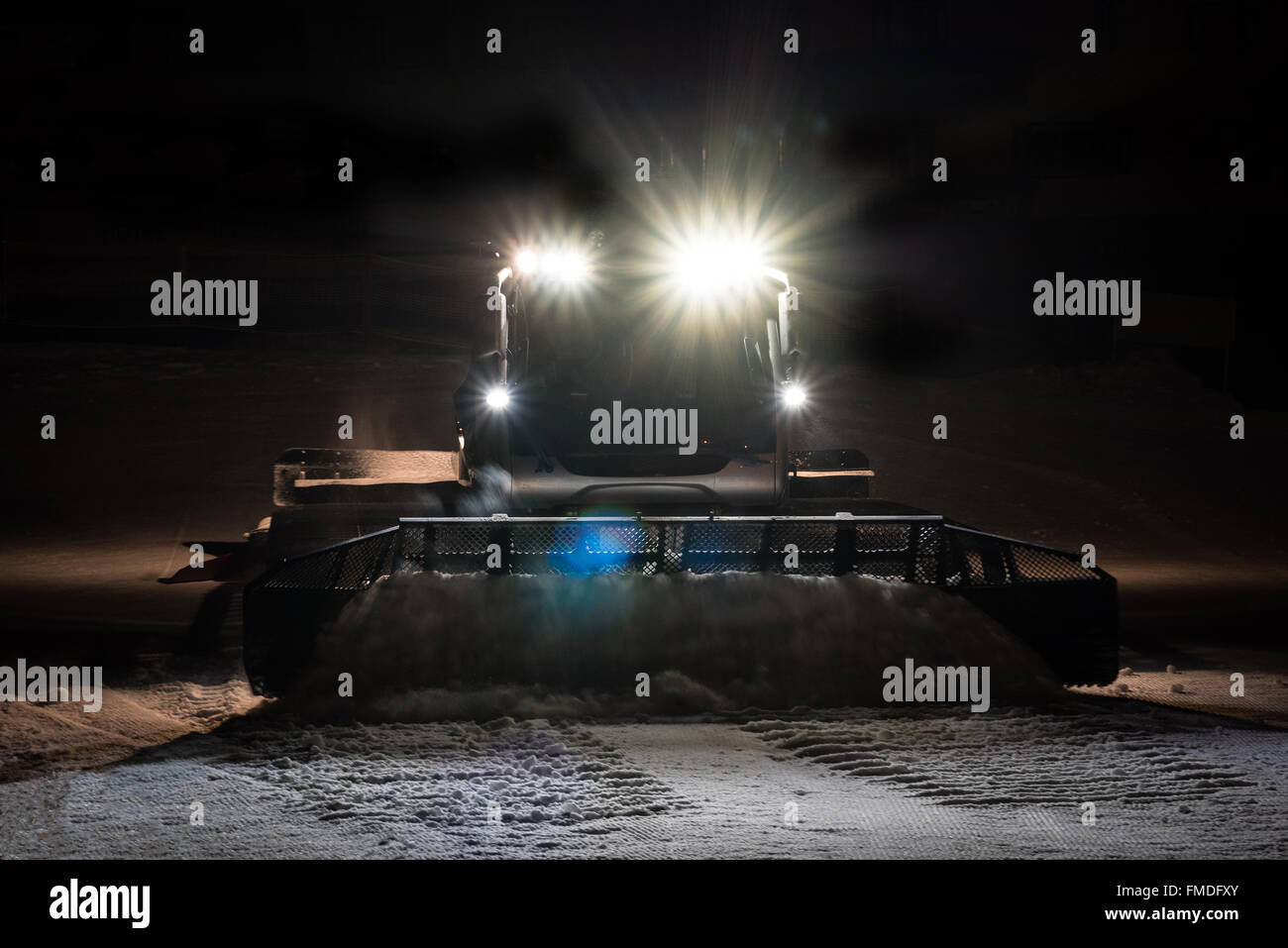 Snowcat preparing a slope at night Stock Photo - Alamy