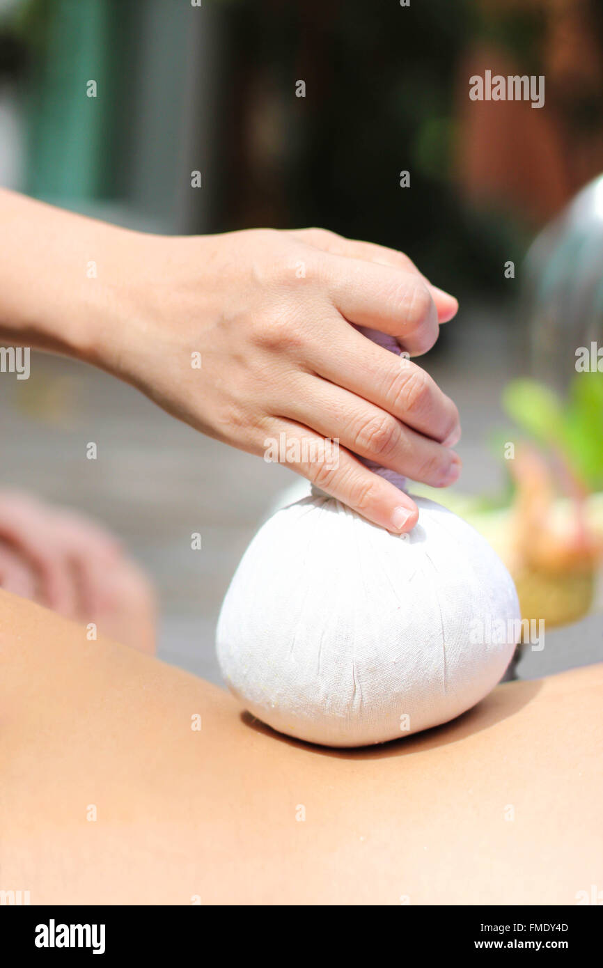 Woman having Thai herbal ball Massage At Health and Beauty Stock Photo