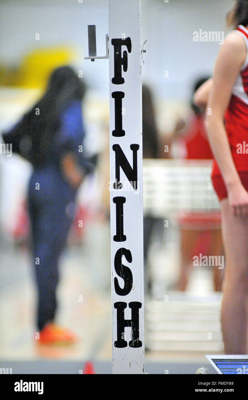 The goal of all runners during track events looms at the end of the race at an indoor high school meet. USA. Stock Photo