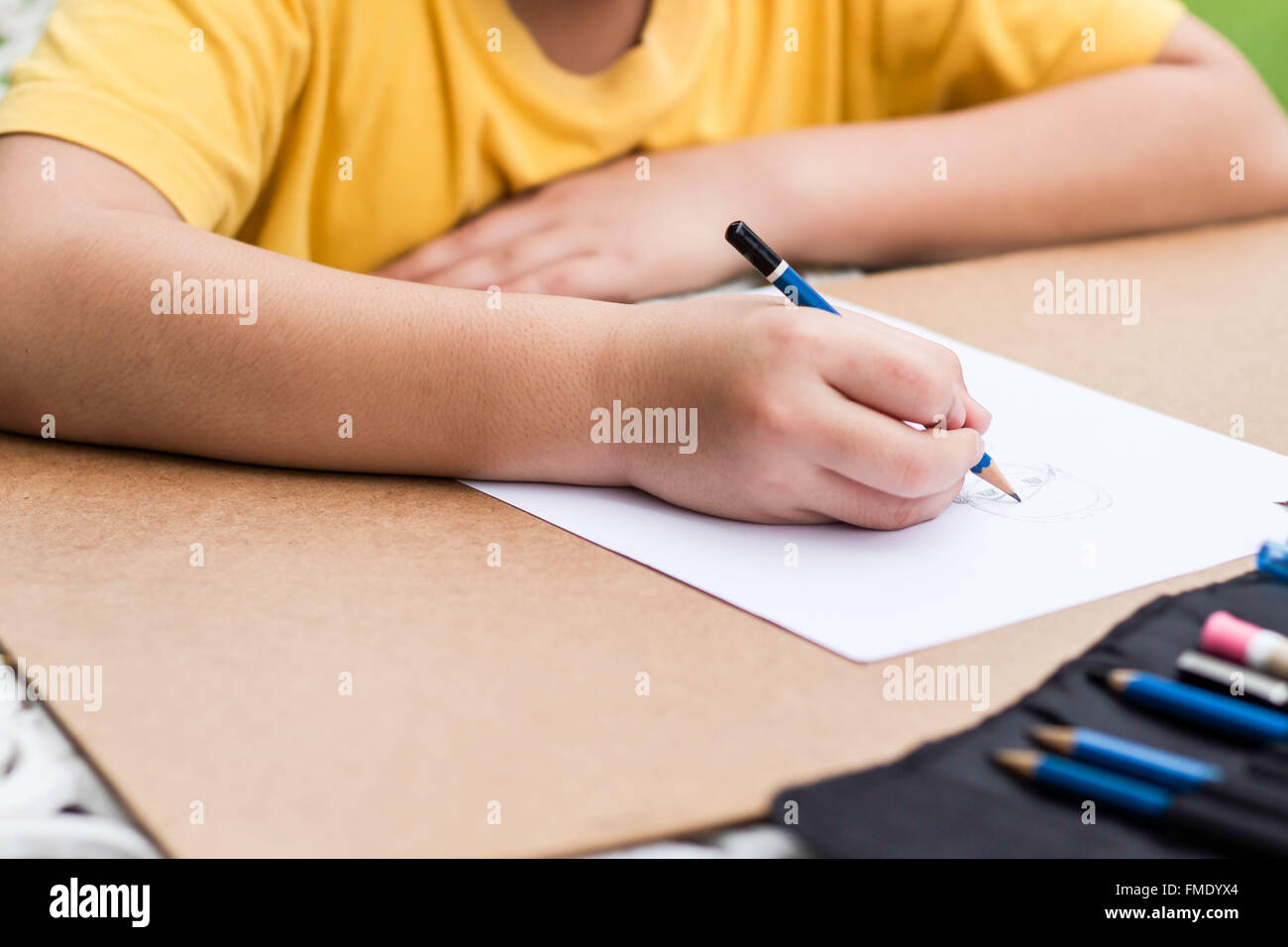 children is drawing a picture with pencil Stock Photo