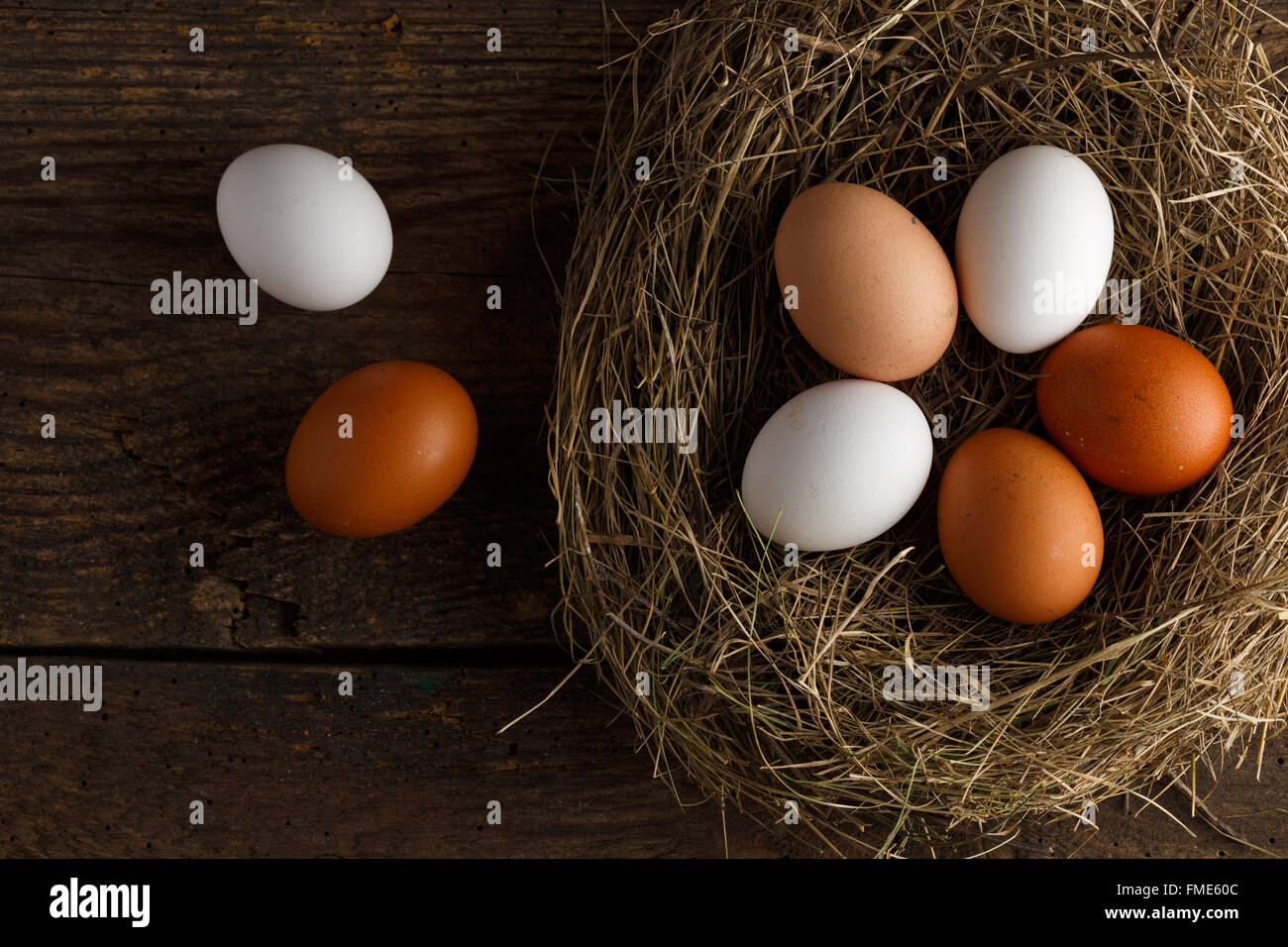 Fresh chicken eggs in a nest on a wooden rustic background Stock Photo ...
