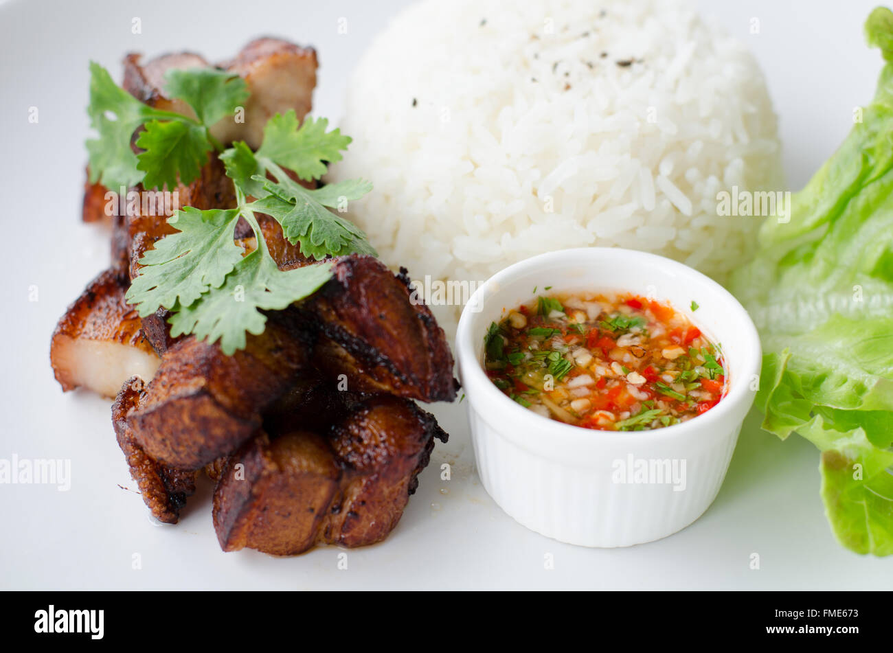 Deep fried pork with rice and chili sauce Stock Photo