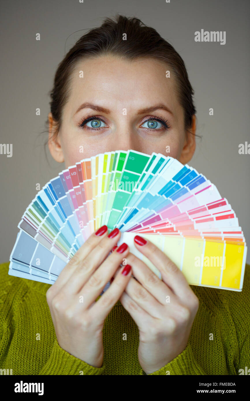 Woman looking to a color paint palette fashion concept Stock Photo Alamy