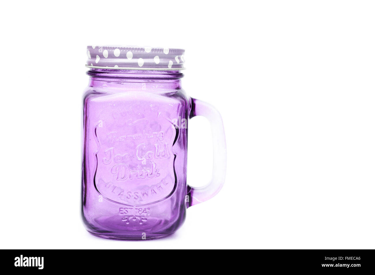 Violet glass cup with lid and straw on a white background isolated. Mason  jar with handle and screwed down cap. Empty mug no spill. Stock Photo