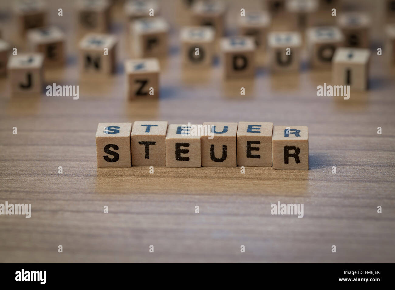 Steuer (German Tax) written in wooden cubes on a table Stock Photo